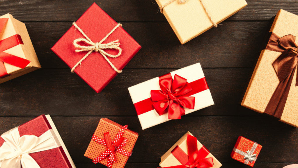 A selection of wrapped presents on a table. Each one is tied with a bow.