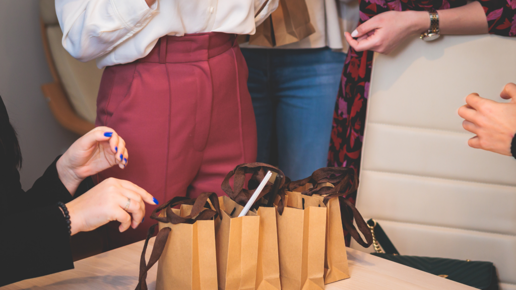 Image of a team giving out gifts for clients in a corporate setting