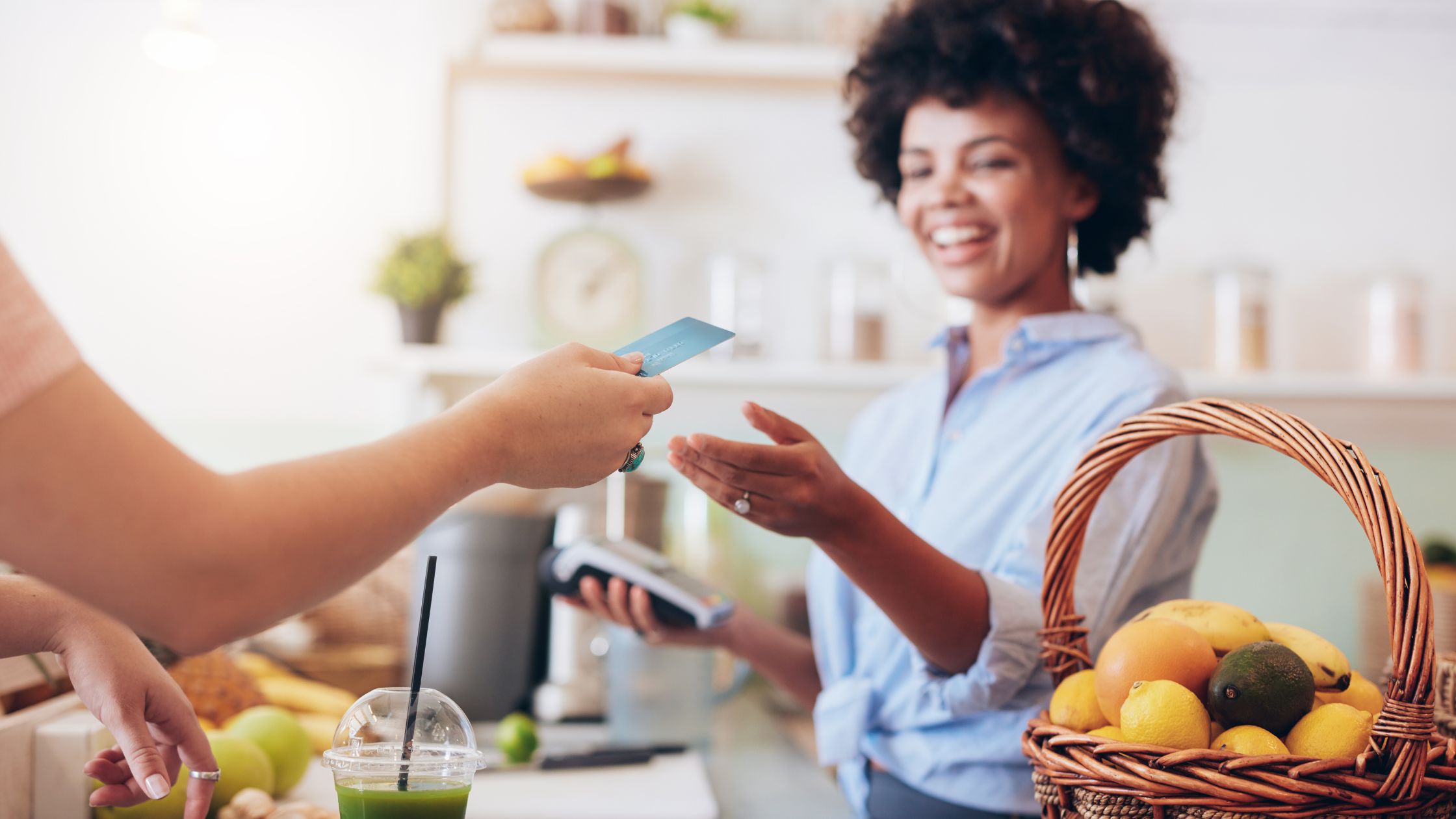 image of a person paying for juice in summer in a cafe with swirl prepaid mastercard